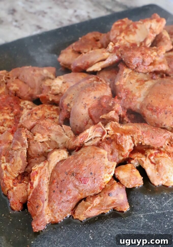 seasoned cooked chicken thighs on cutting board