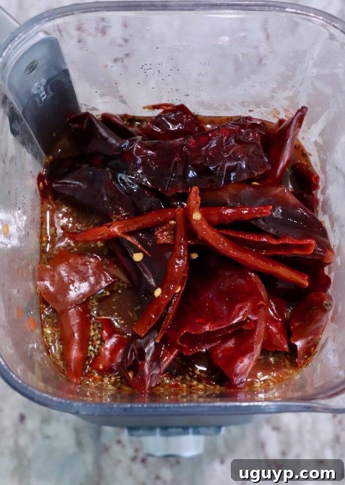 dried chiles in blender with tomatoes and vinegar