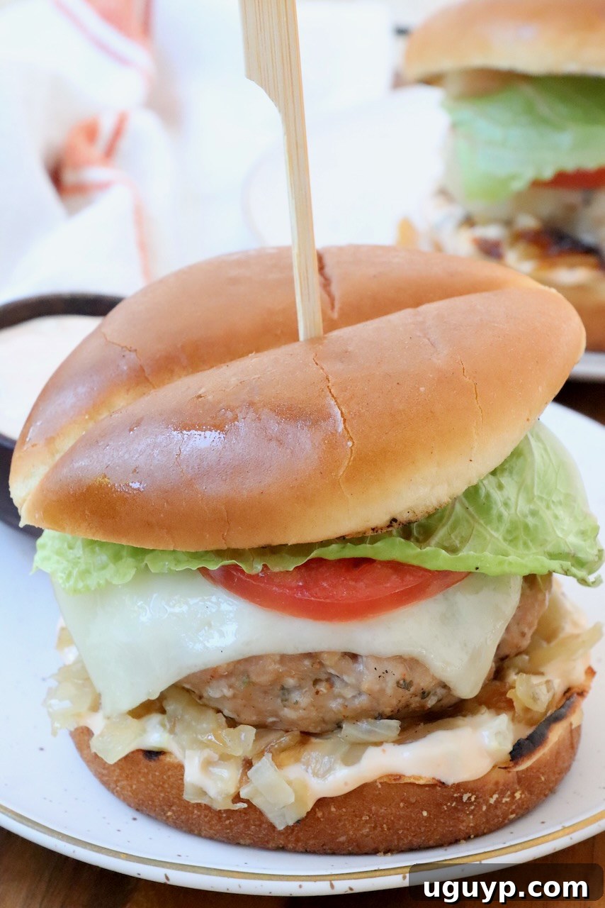 Delicious and juicy turkey burger on a plate with fresh ingredients