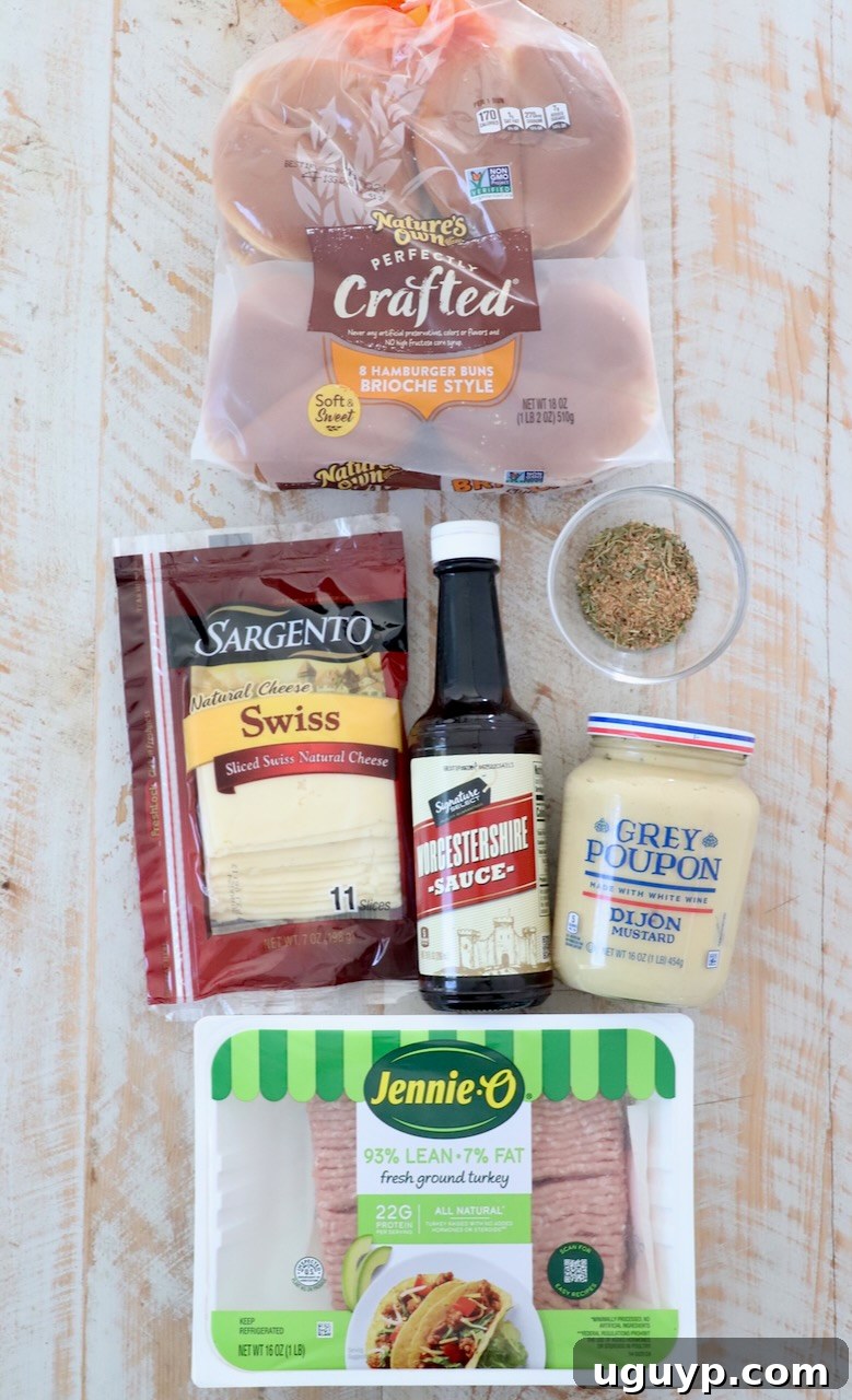 Ingredients for homemade turkey burgers laid out on a white wooden board