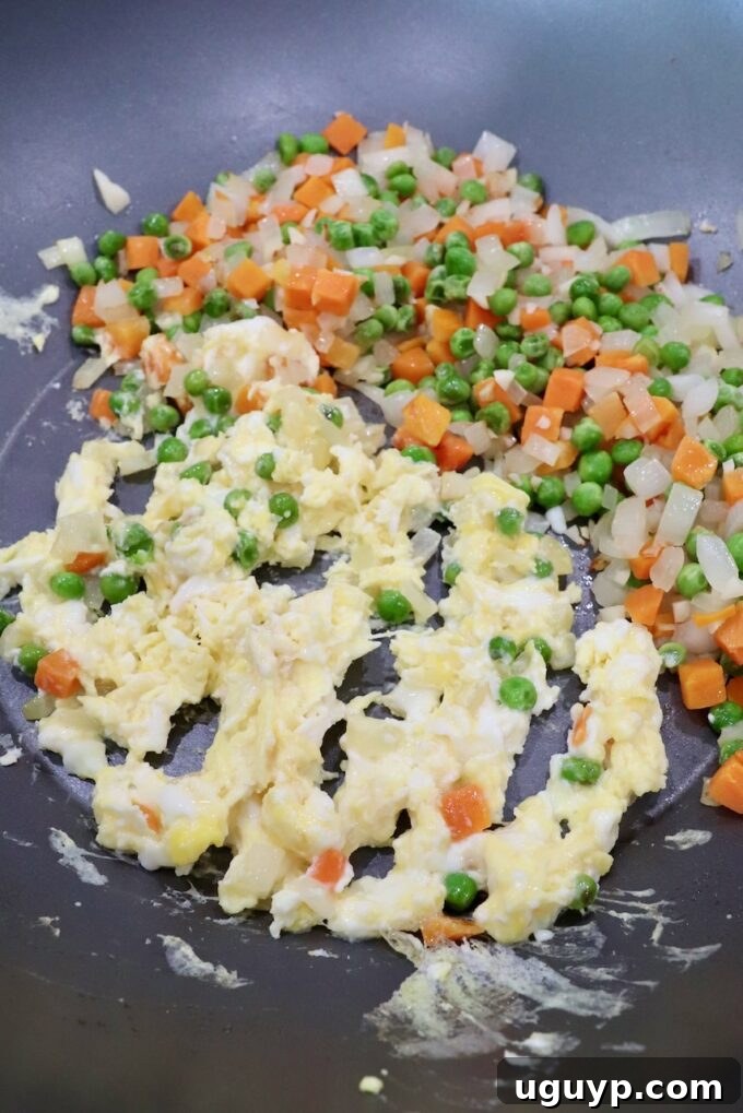 diced veggies and scrambled eggs mixed together in a large skillet