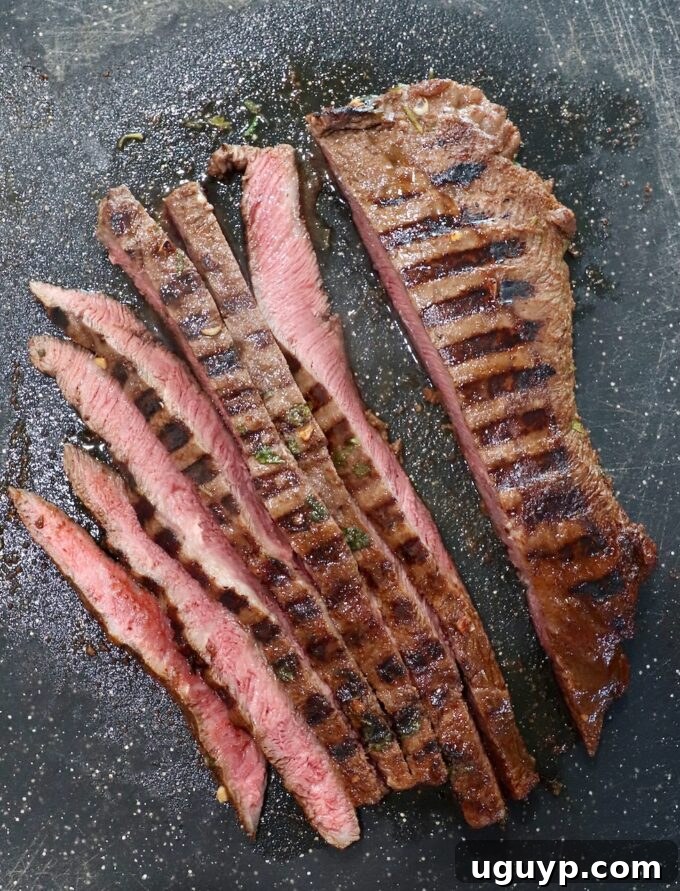 Grilled flat iron steak, expertly sliced against the grain, ready for taco assembly.