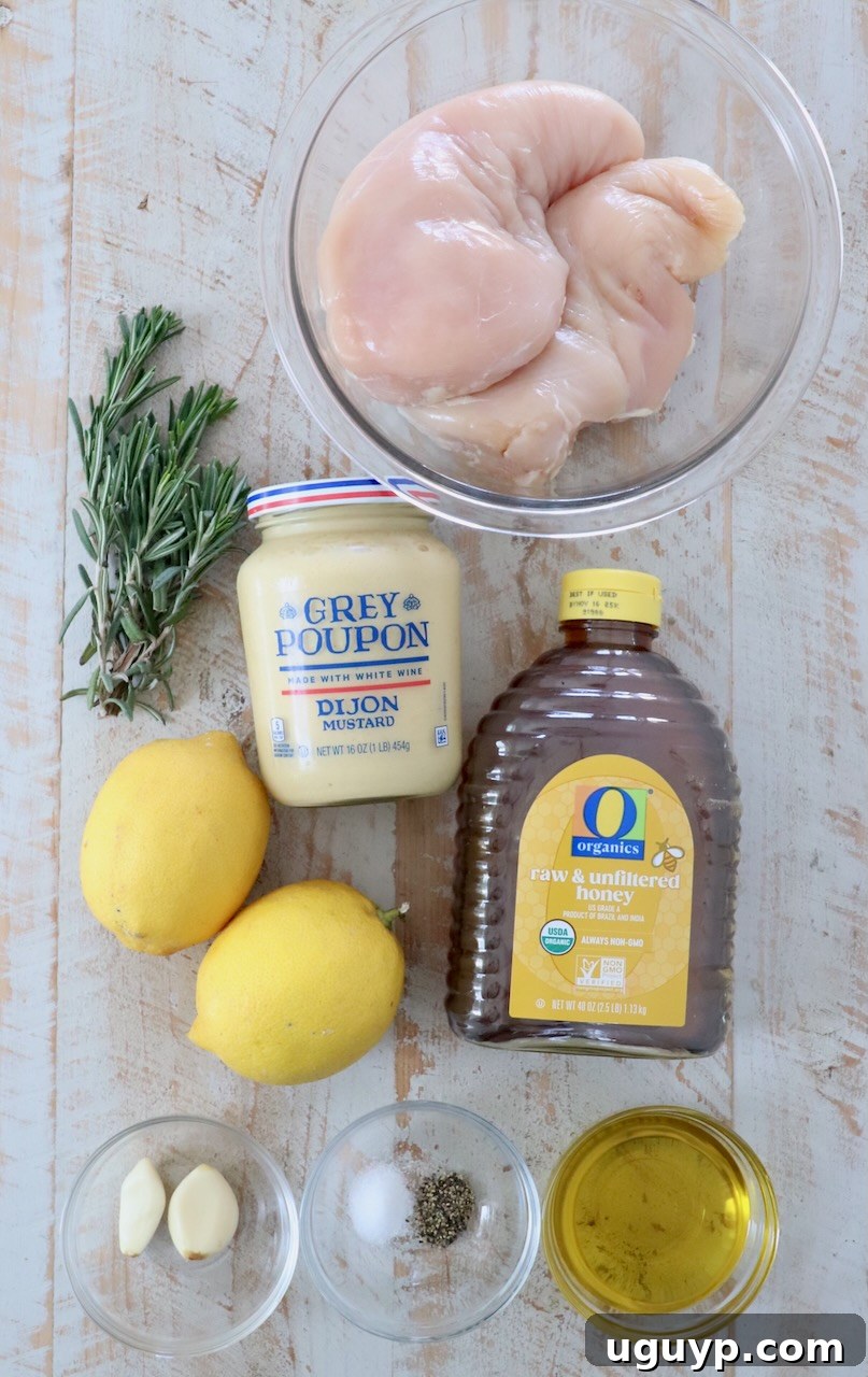 ingredients for honey mustard chicken on white wood board