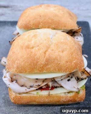 uncooked turkey sandwich on cutting board