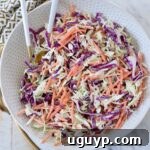 coleslaw in bowl with spoons