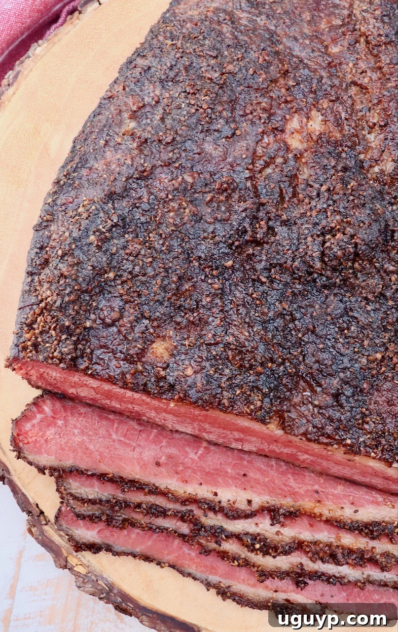 smoked pastrami brisket resting on a wood board after cooking