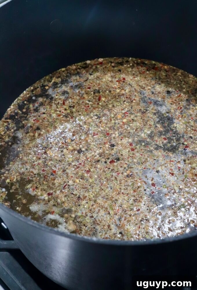 brine for pastrami simmering in a large pot on the stove