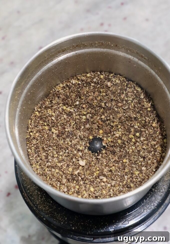 ground spices in a spice grinder, showing a coarse texture