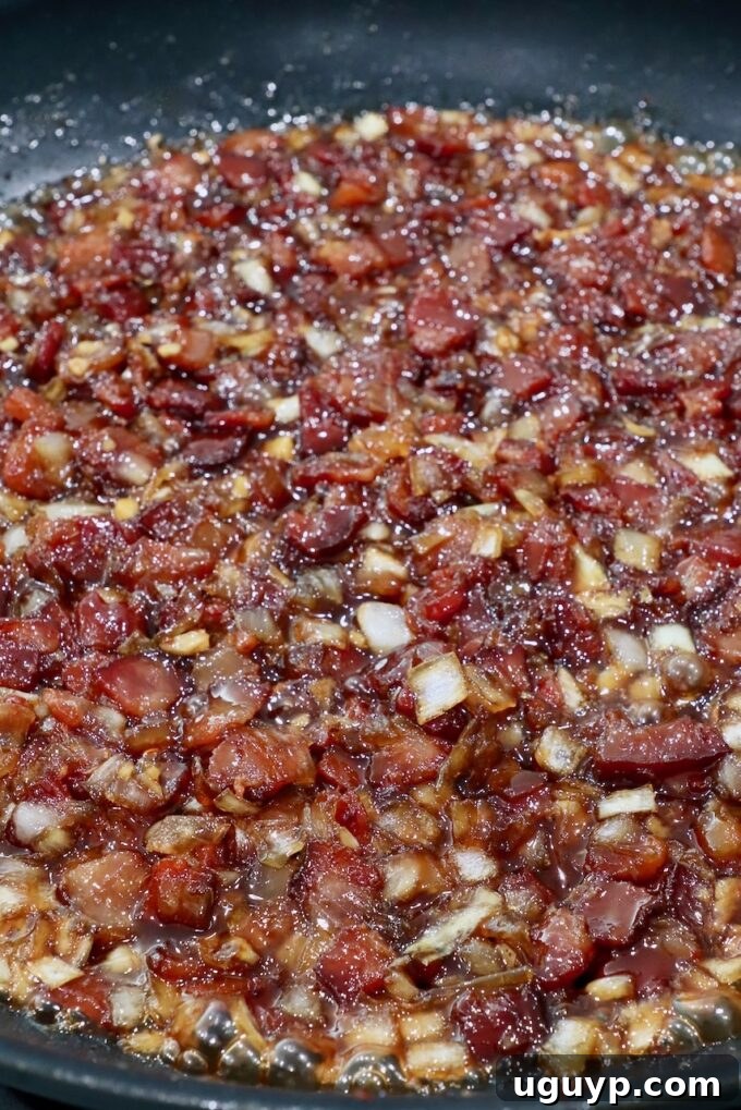 Finished bacon jam in a skillet, rich, thick, and ready to be cooled.