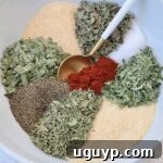 dried herbs and spices separated in bowl with spoon for vegetable seasoning