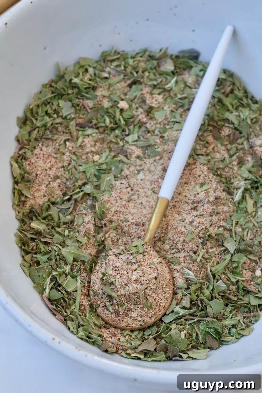 vegetable seasoning mixed together in a bowl with a spoon, ready to be transferred to storage