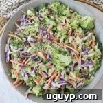 Creamy broccoli slaw in a bowl, a perfect summer side dish.
