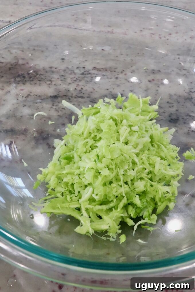 Freshly shredded broccoli collected in a mixing bowl.