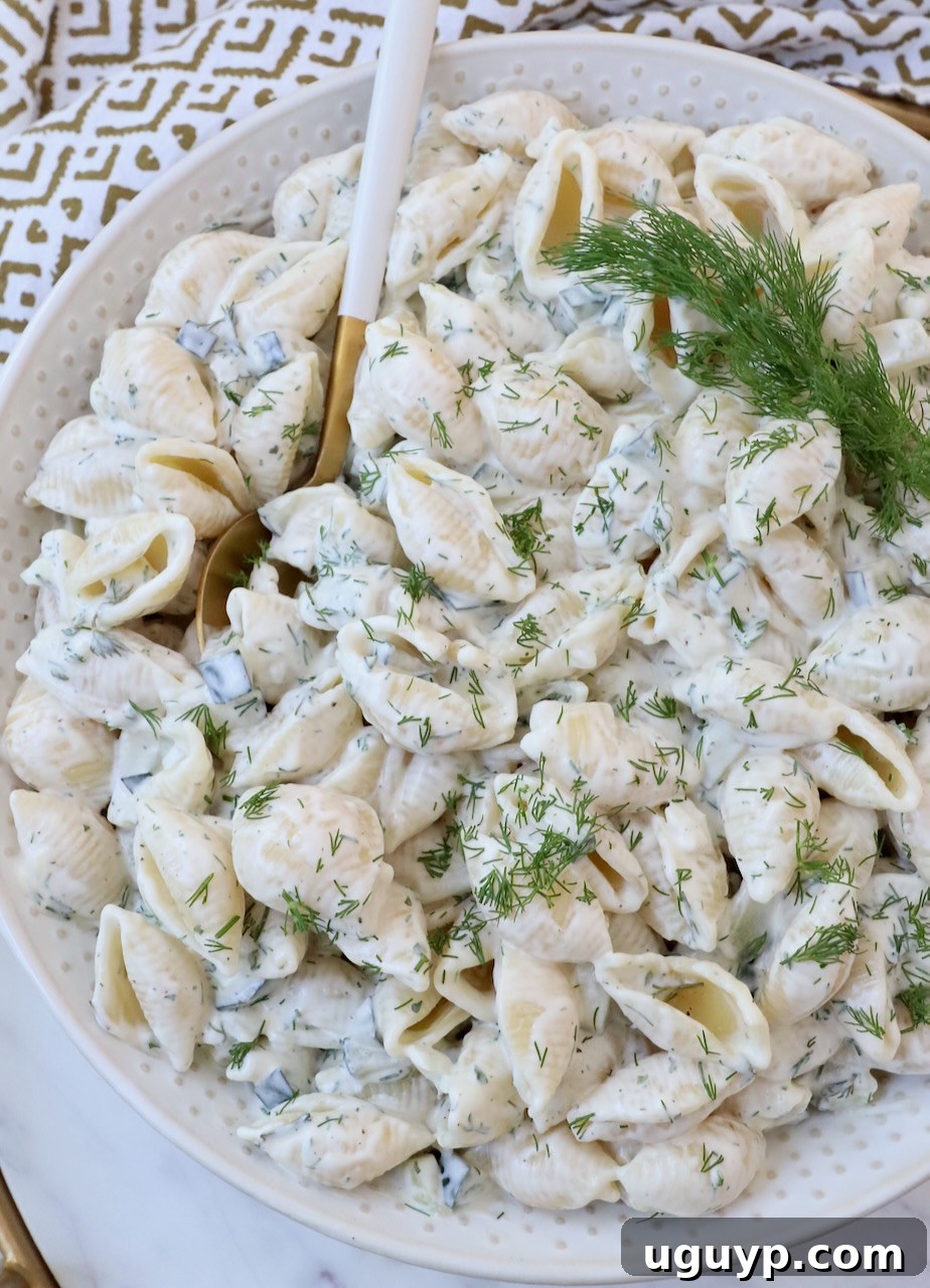 creamy pasta salad in bowl topped with fresh dill