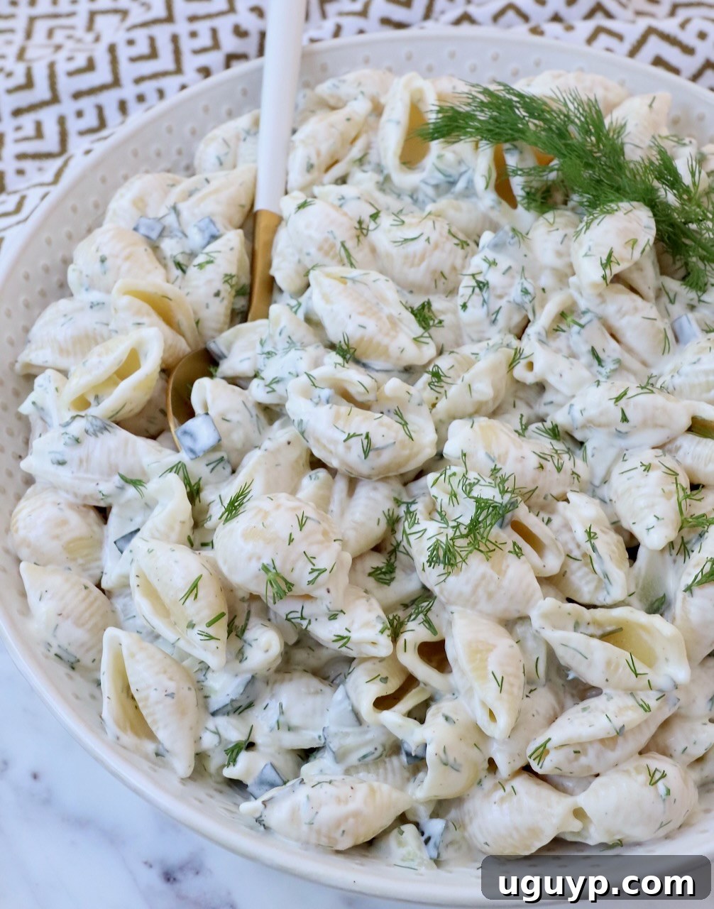 creamy pickle pasta salad in bowl with spoon