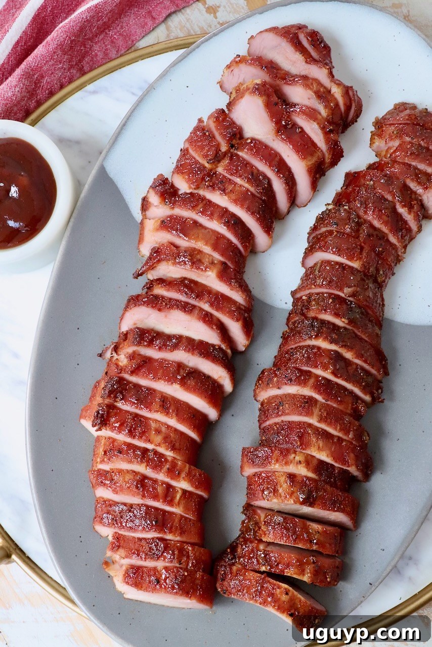 smoked pork tenderloin sliced on plate