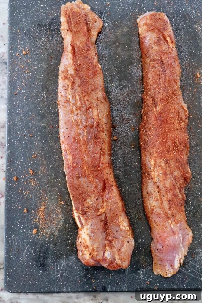 seasoned pork tenderloins on cutting board