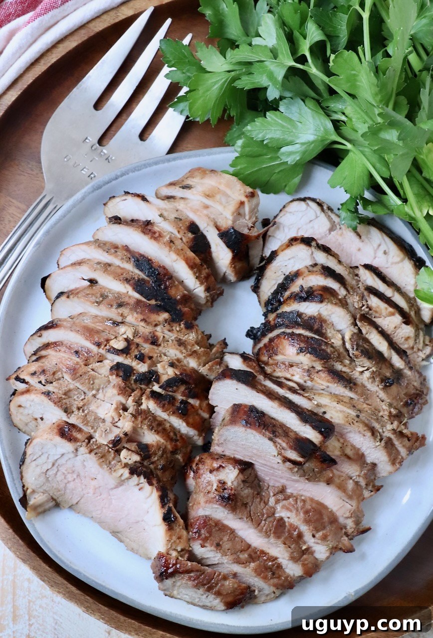 Close-up of perfectly sliced grilled pork tenderloin on a plate