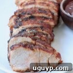 Grilled pork tenderloin sliced on plate