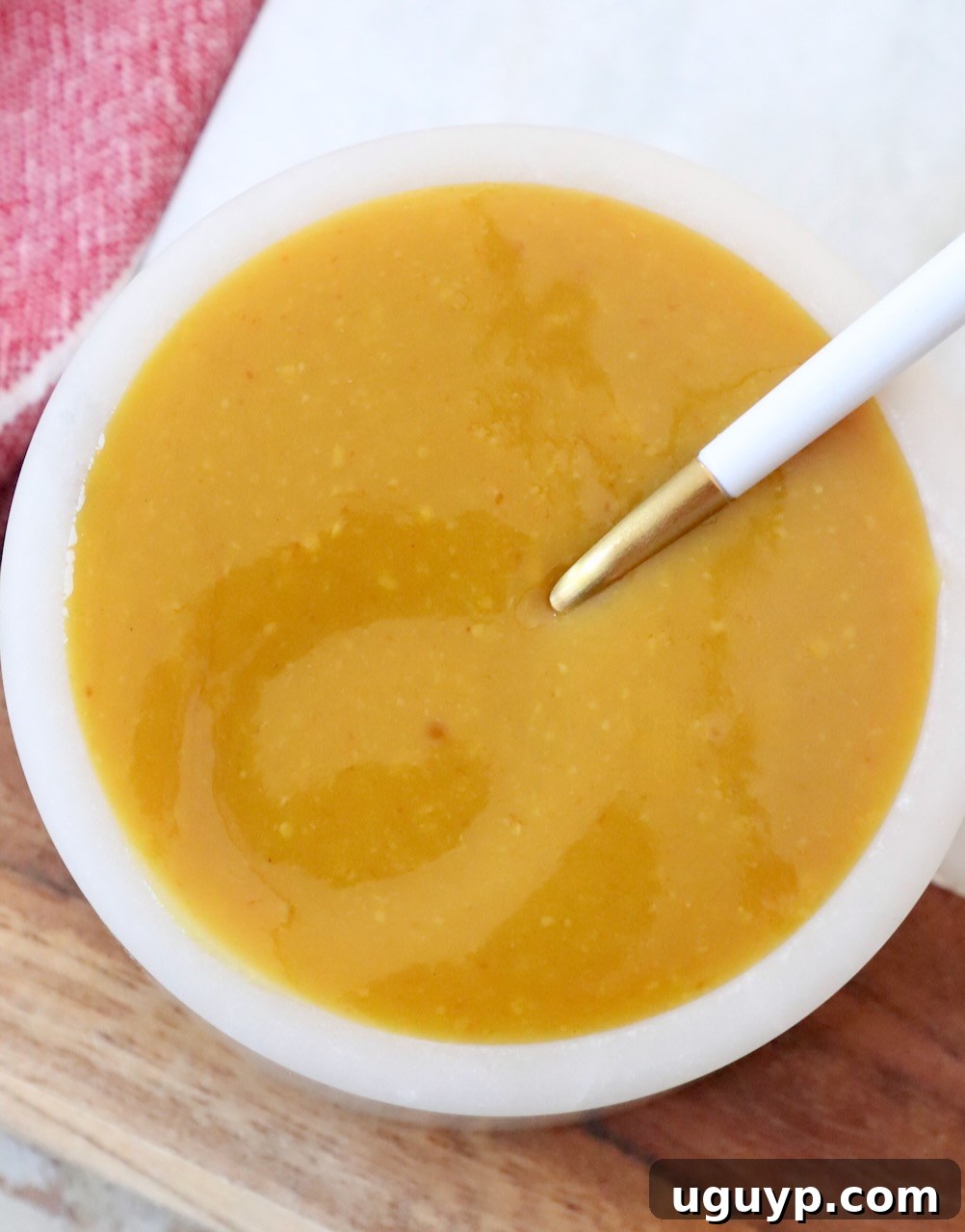 mustard bbq sauce in bowl with spoon