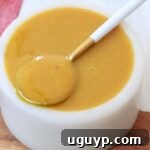Carolina gold bbq sauce in small bowl with spoon