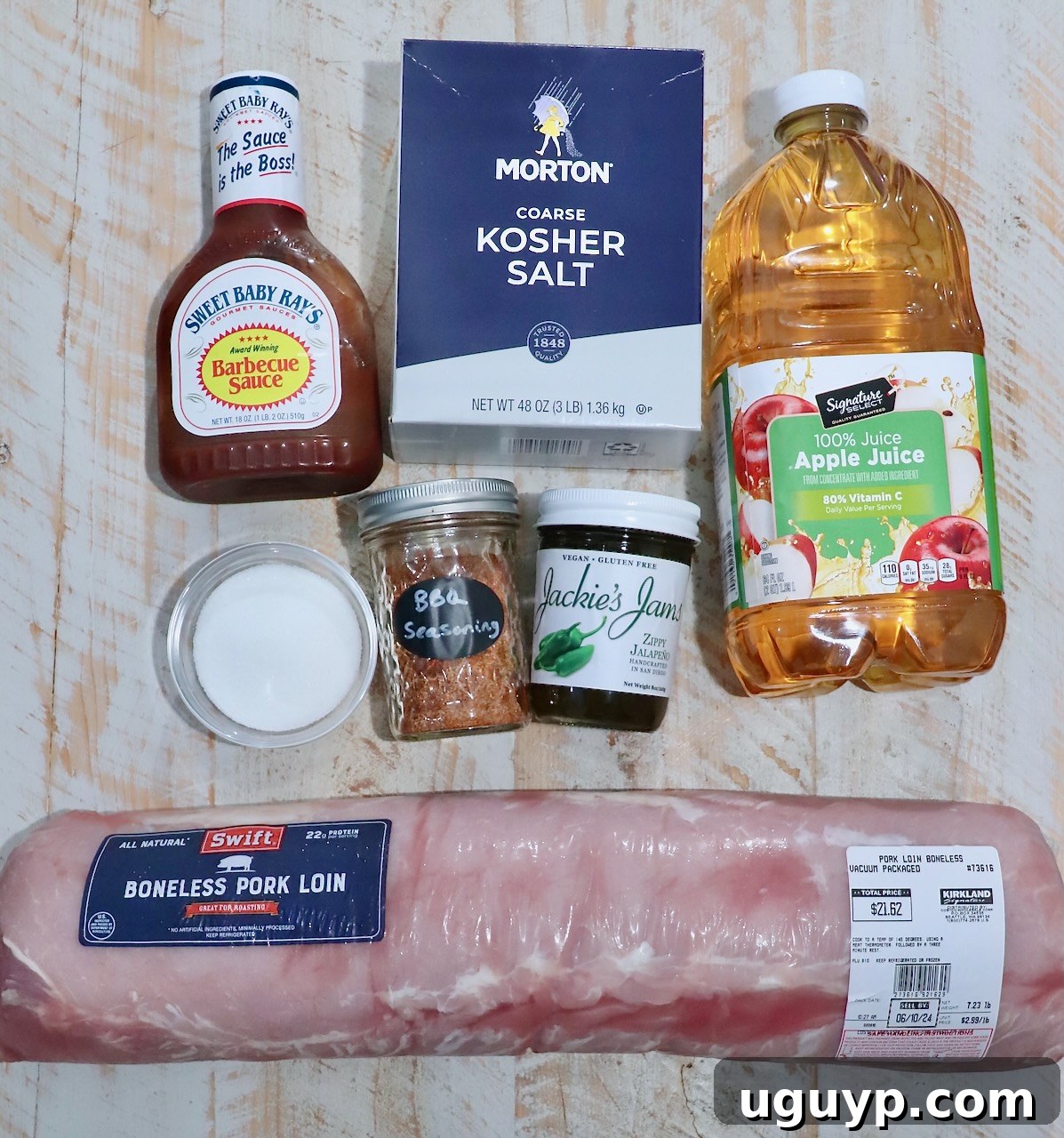 All the fresh ingredients for making the best smoked pork loin laid out neatly on a rustic white wooden board, ready for preparation and brining.