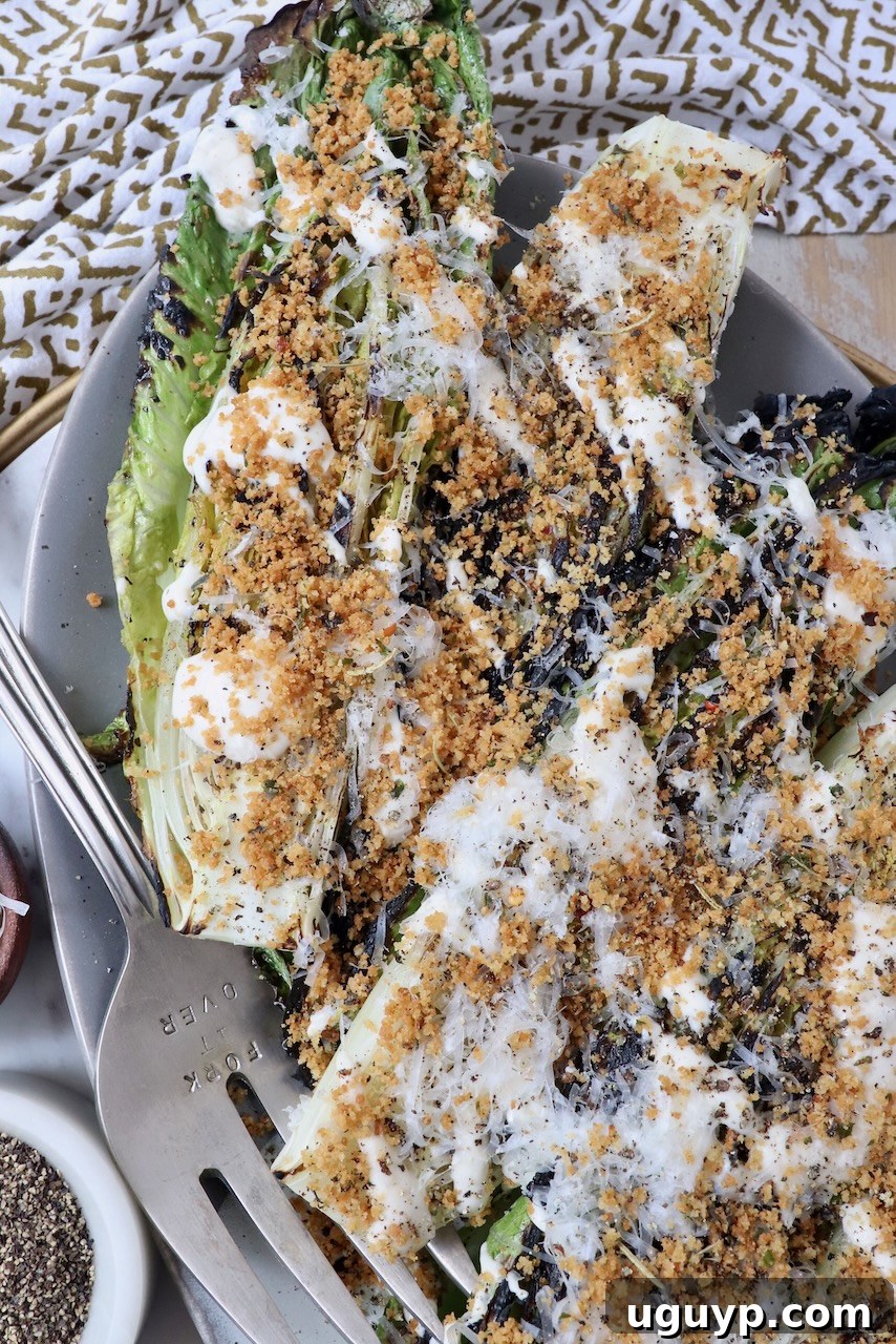grilled caesar salad on plate with serving fork