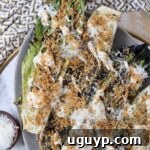 grilled romaine lettuce caesar salad on plate topped with toasted breadcrumbs