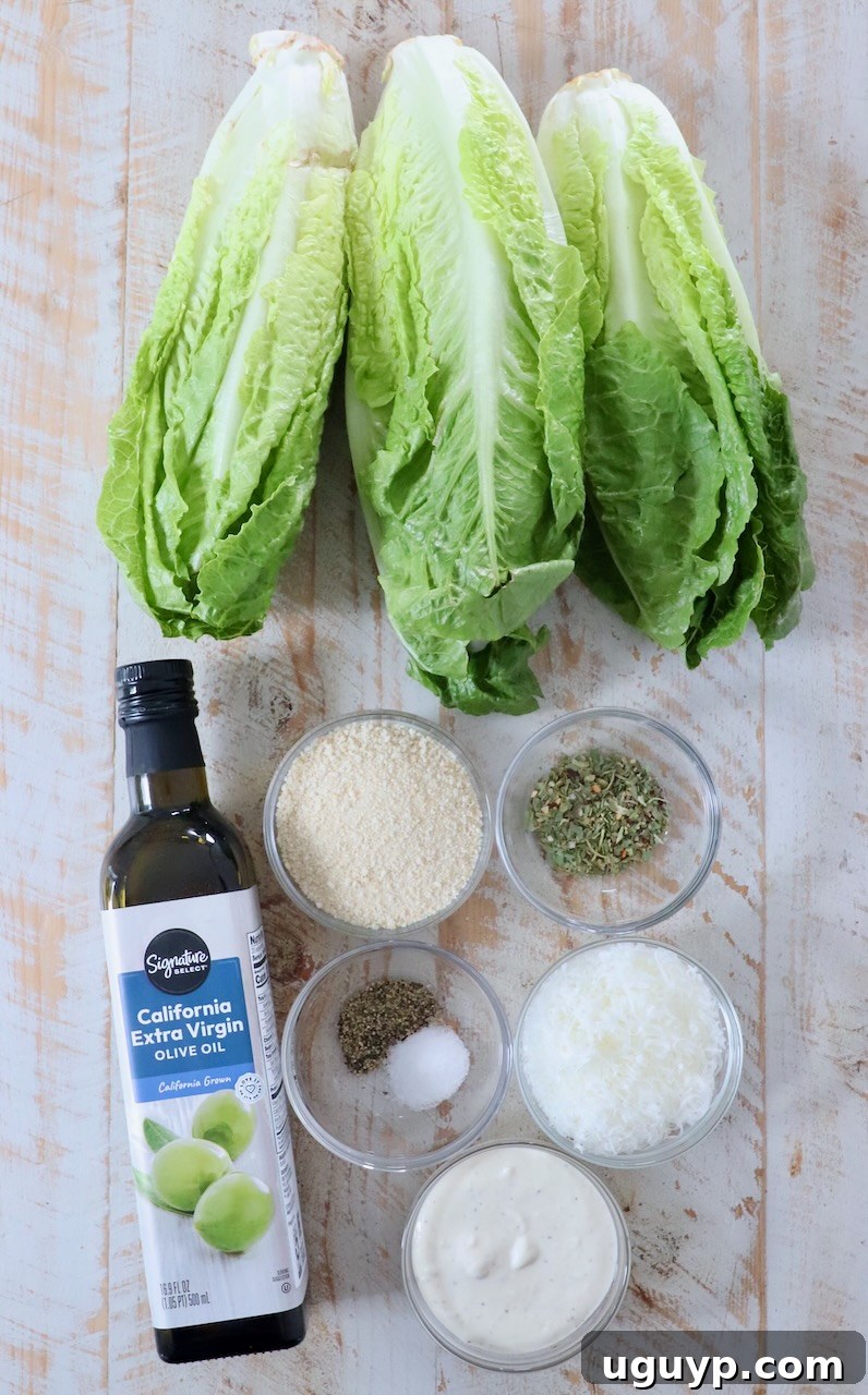 ingredients for grilled caesar salad on white wood board