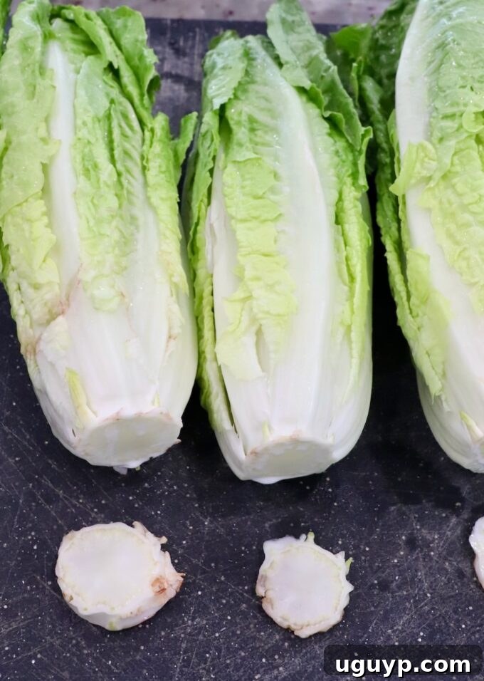 romaine lettuce on cutting boards with the stems cut off