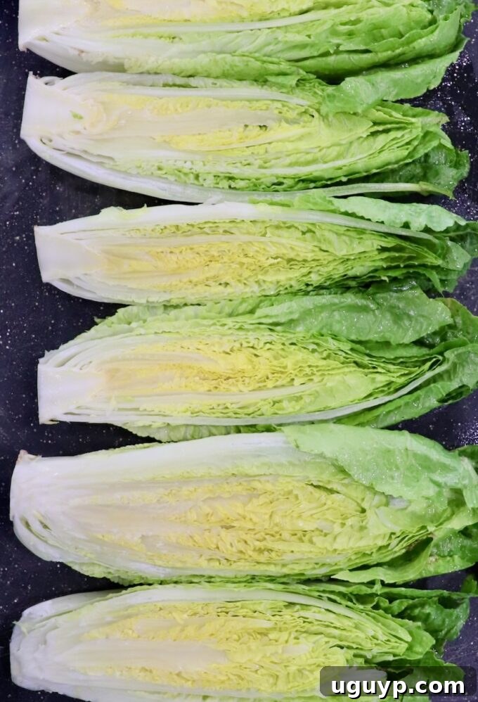 romaine lettuce hearts cut in half on cutting board