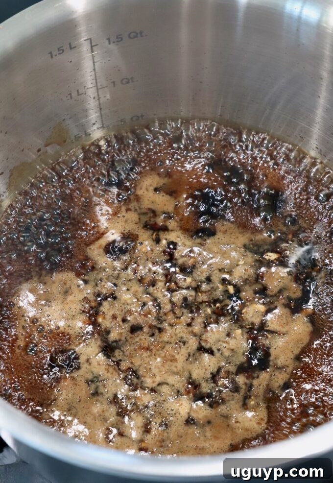 teriyaki sauce bubbling in pot on the stove