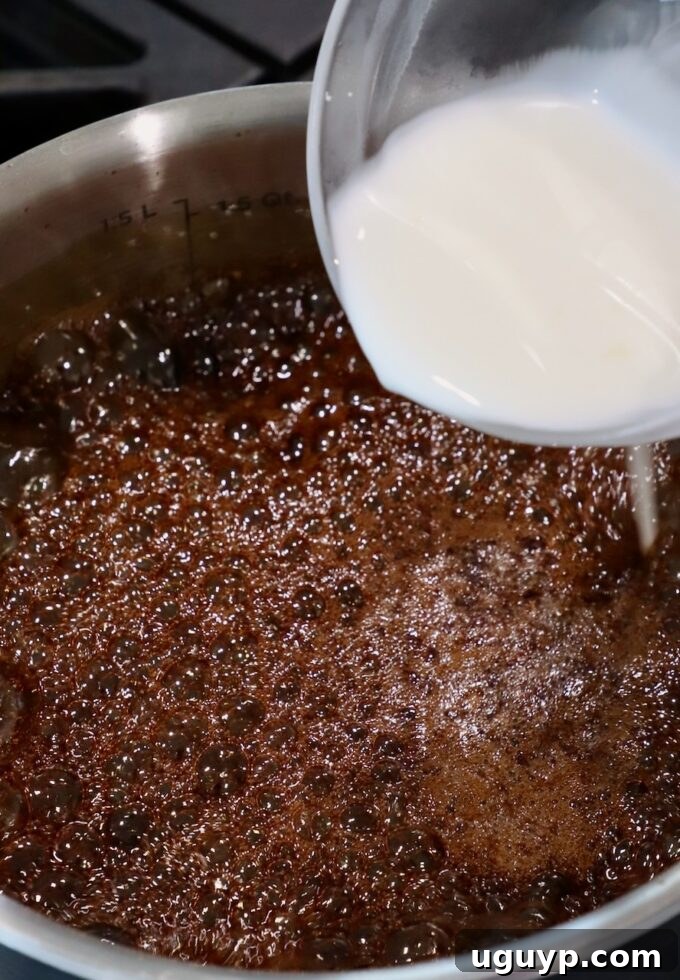 cornstarch slurry poured into a pot of teriyaki sauce on the stove