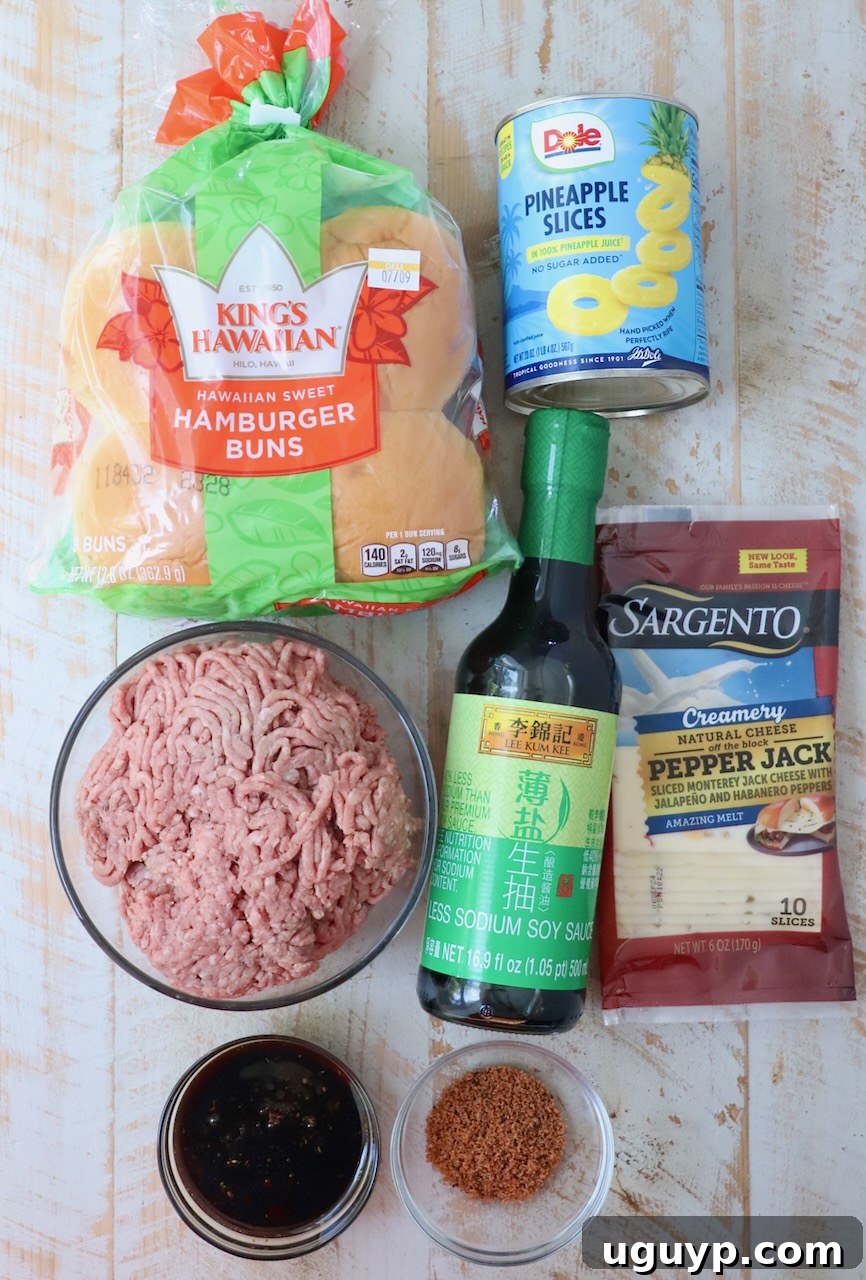 ingredients for Hawaiian burgers on white wood board