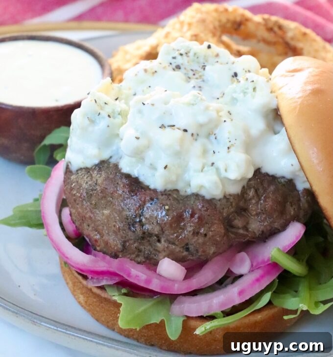 Grilled Burger Patty Topped with Blue Cheese Sauce on a Plate