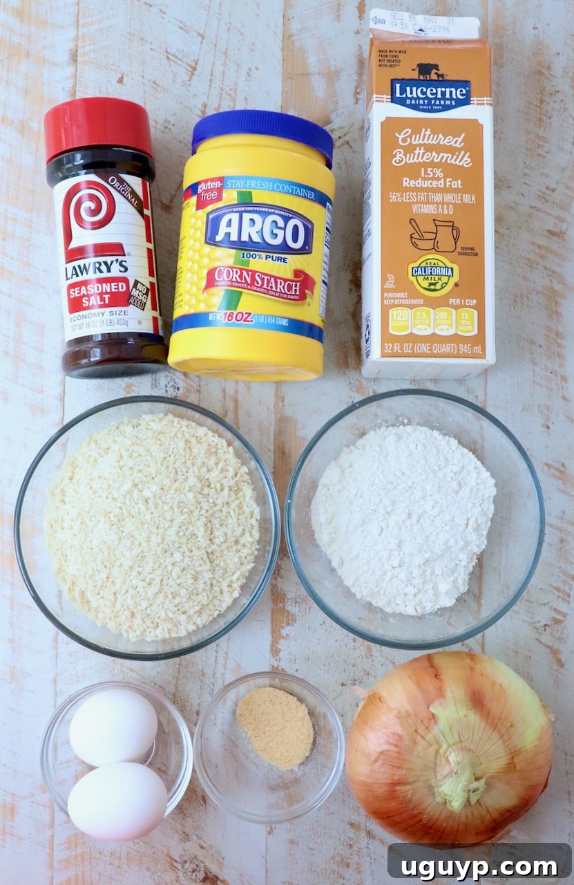 ingredients for onion rings on white wood board