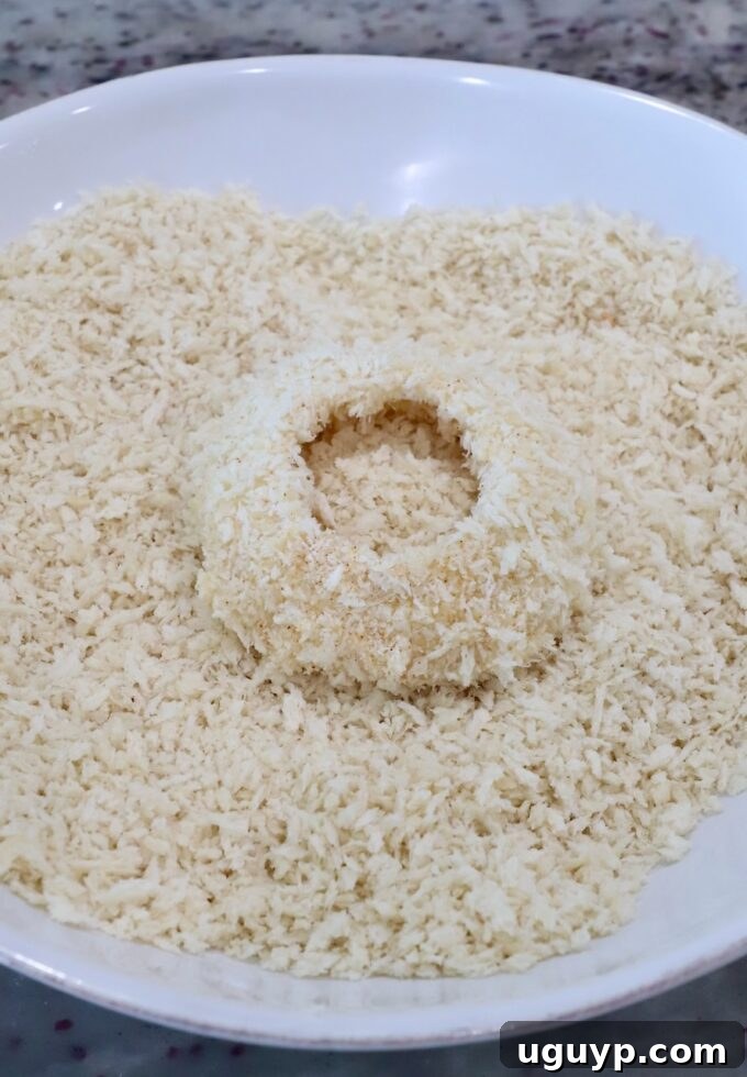 a slice of onion in a bowl of breadcrumbs