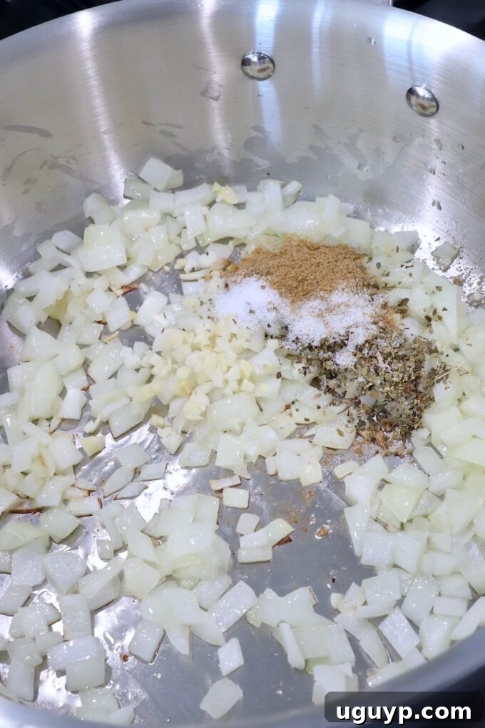 diced onions and garlic in pan with spices