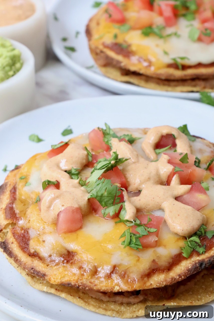 Mexican pizza topped with creamy jalapeno sauce on a plate