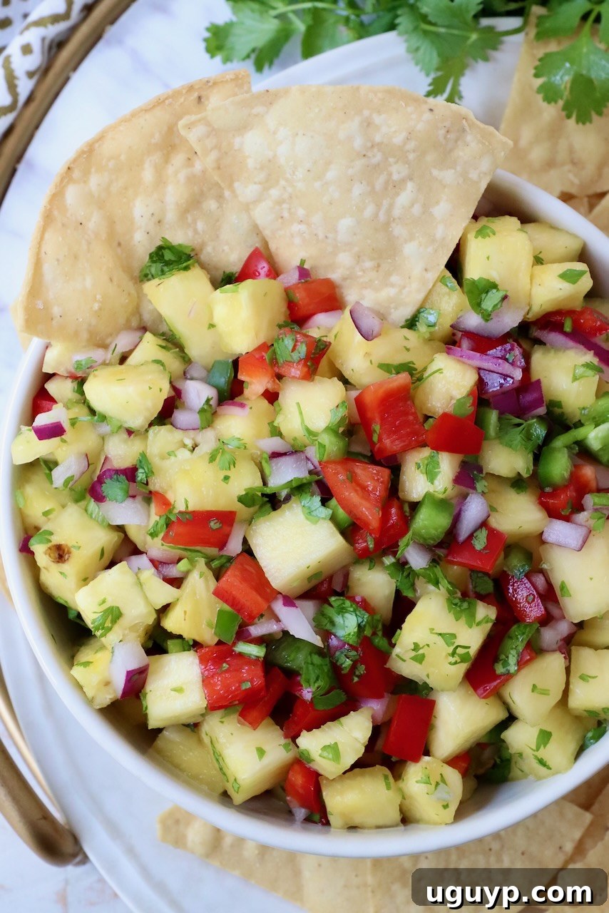 pineapple salsa in bowl with tortilla chips, inviting and vibrant