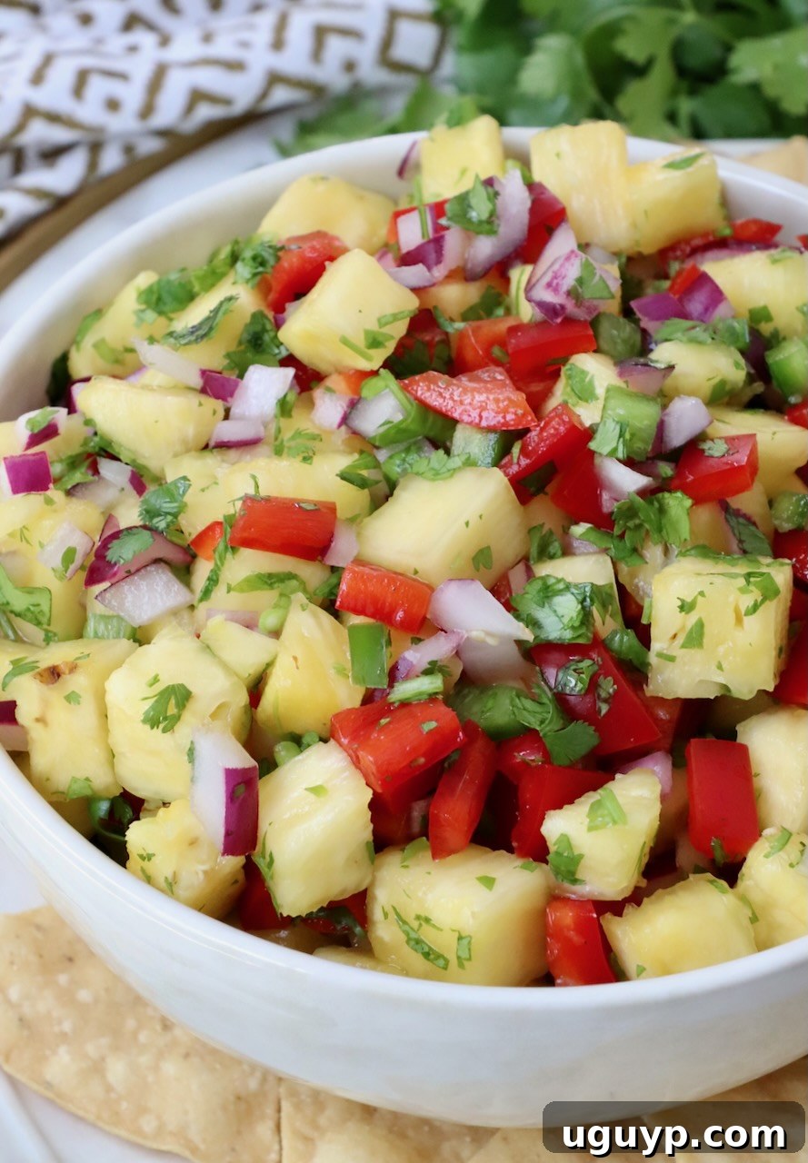 close-up of pineapple salsa in a small bowl, showcasing its fresh ingredients and vibrant colors