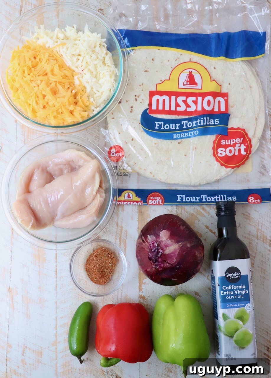 A collection of fresh ingredients for chicken quesadillas laid out on a white wooden board: chicken breasts, colorful bell peppers, red onion, jalapeno, tortillas, and a bowl of shredded cheese.