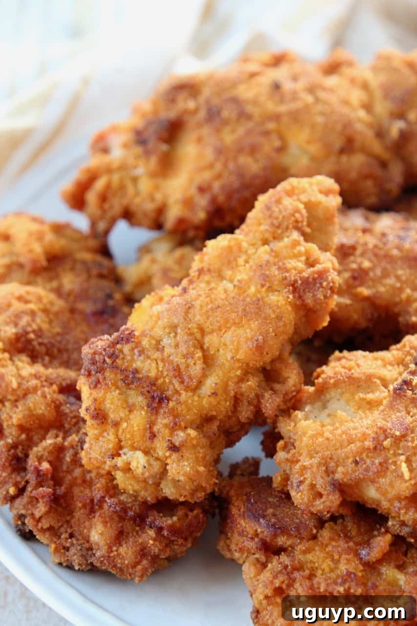A close-up view of golden-brown Captain Crunch fried chicken tenders, perfectly stacked and ready to eat.