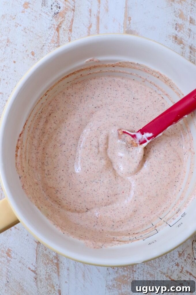 chili lime dressing in a mixing bowl with a spatula