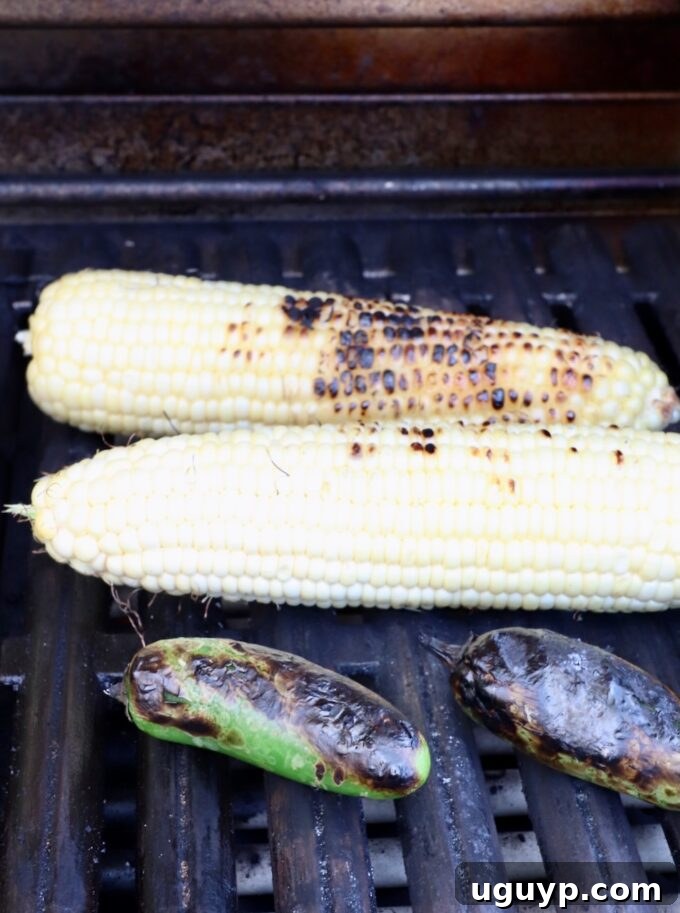 grilled corn on the cob and jalapenos on a grill