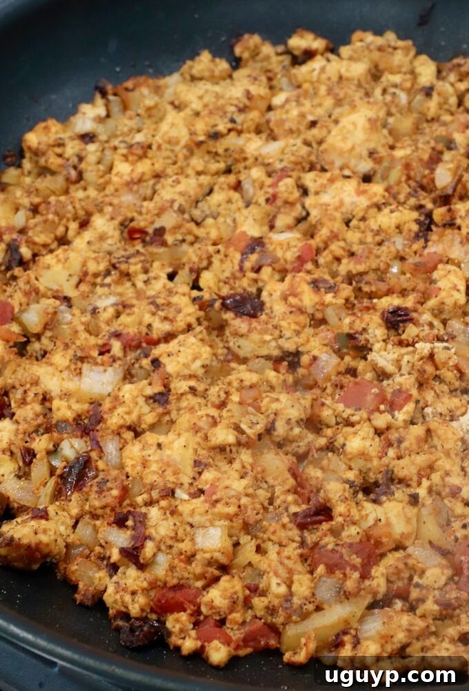 seasoned, cooked, crumbled tofu in a skillet