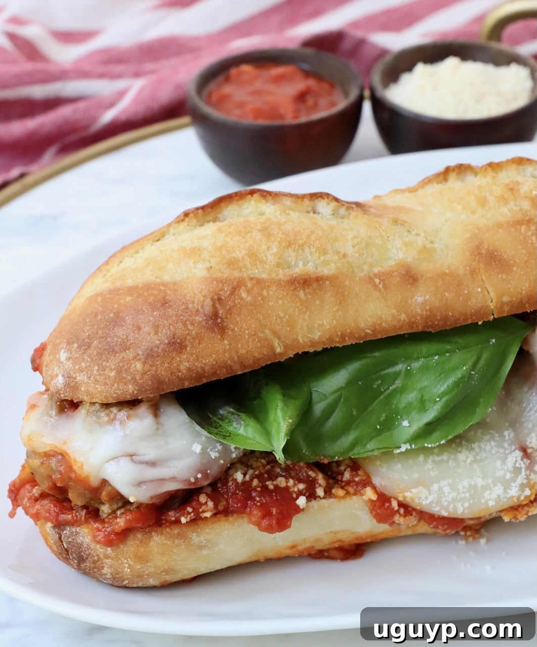 Perfectly assembled Italian meatball sub on a plate, ready to be enjoyed.