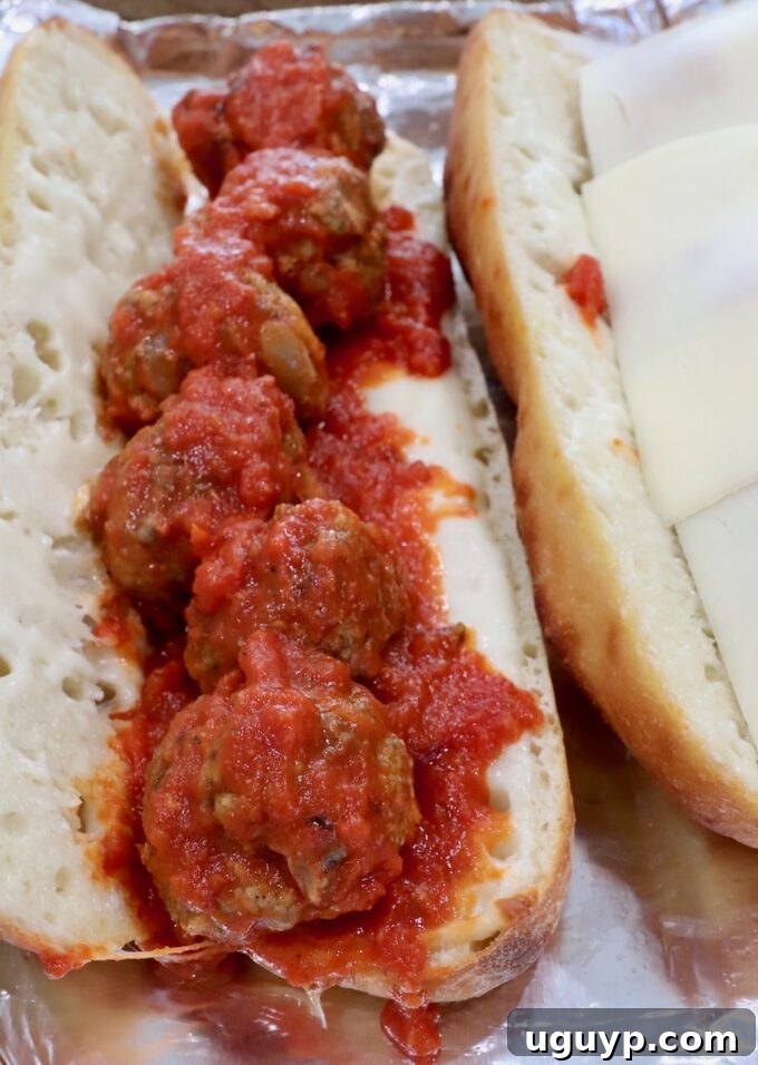 Delicious meatballs tossed in marinara sauce nestled inside a baguette with melted cheese.