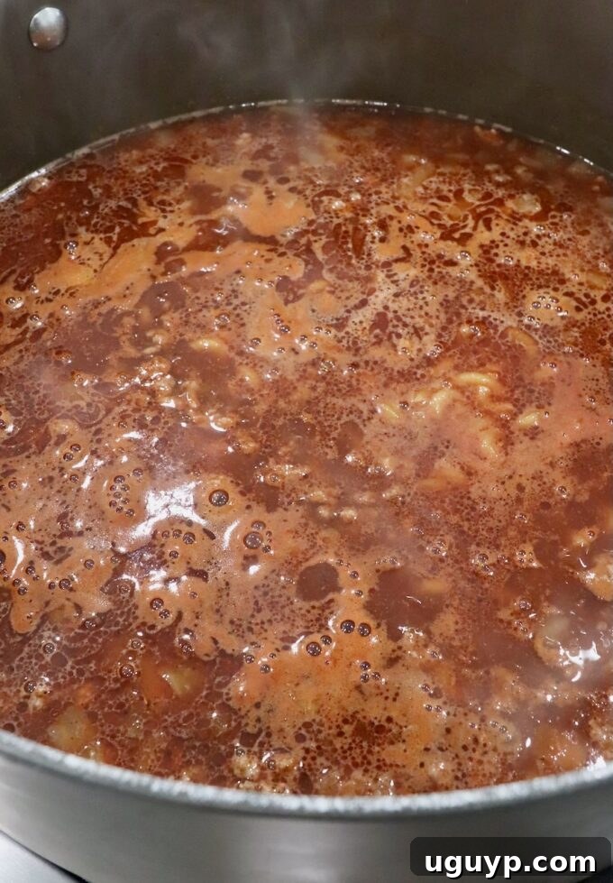 bubbling beef broth in a large pot