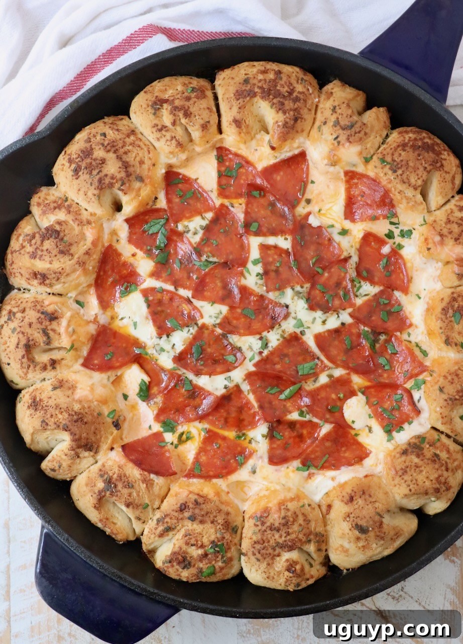 pizza dip surrounded by pull apart bread in a large skillet